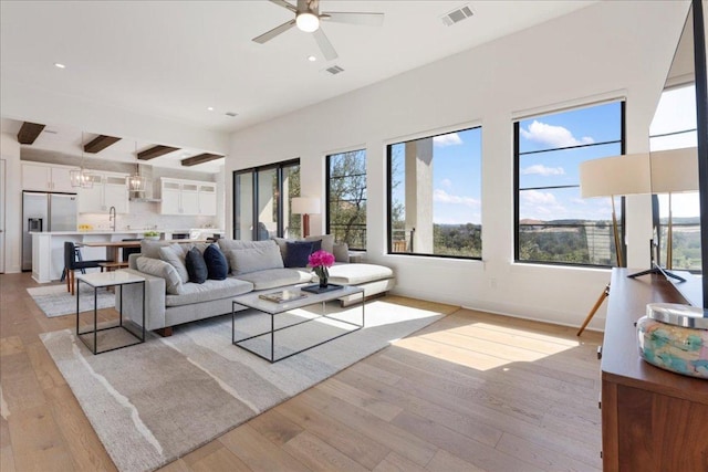 living area with recessed lighting, light wood-style floors, visible vents, and ceiling fan