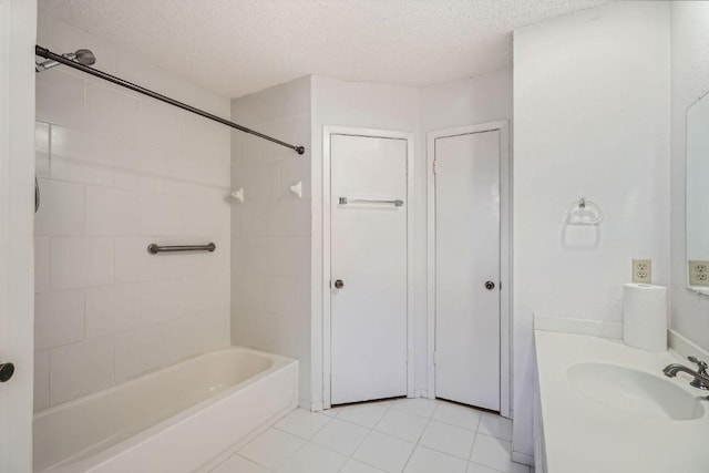 bathroom featuring a textured ceiling,  shower combination, tile patterned flooring, and vanity