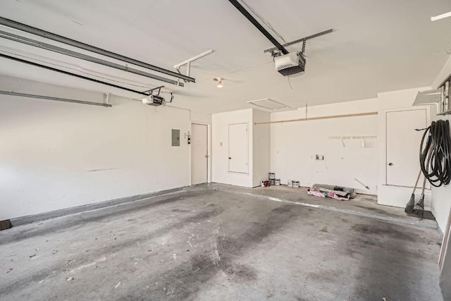 garage featuring electric panel and a garage door opener