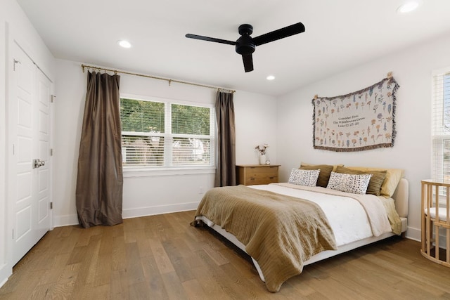 bedroom featuring baseboards, wood finished floors, a ceiling fan, and recessed lighting