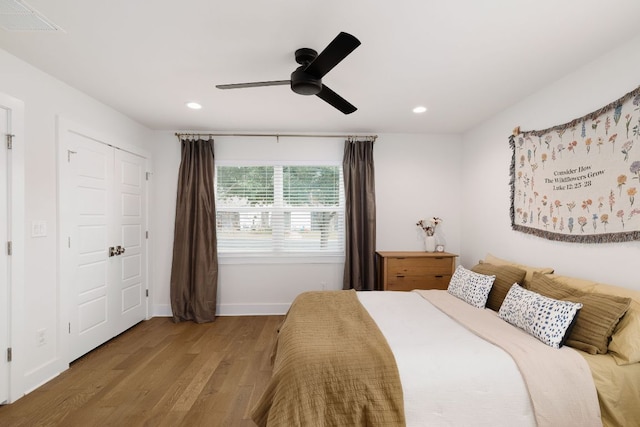 bedroom with recessed lighting, visible vents, baseboards, and wood finished floors