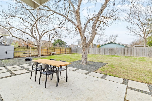 view of patio / terrace featuring an outdoor fire pit, a fenced backyard, and an outdoor structure