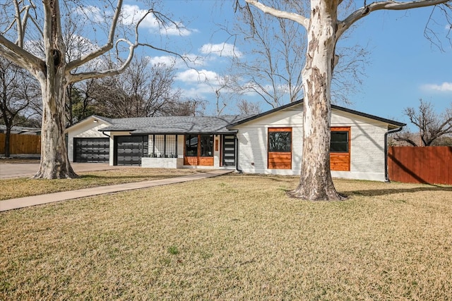 mid-century home with a garage, driveway, brick siding, fence, and a front yard