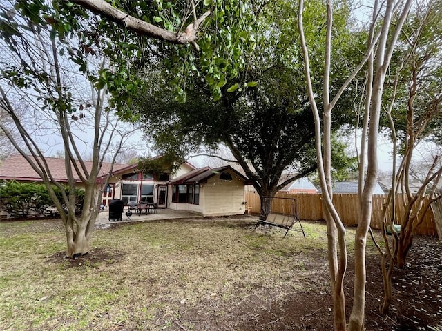 view of yard featuring a patio area and a fenced backyard