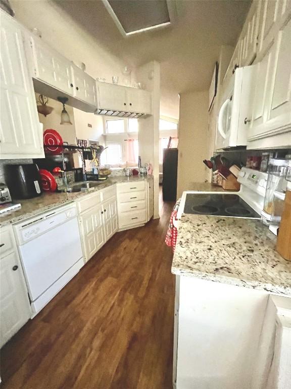 kitchen featuring white cabinets, white appliances, light countertops, and dark wood-type flooring