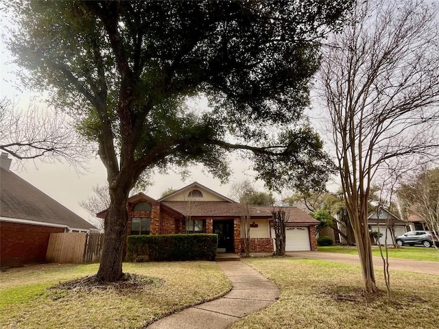 single story home featuring driveway, brick siding, an attached garage, and a front yard