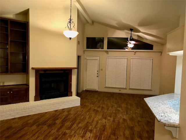 unfurnished living room with vaulted ceiling with beams, a brick fireplace, ceiling fan, and wood finished floors