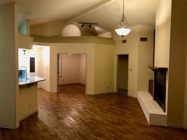 unfurnished living room featuring high vaulted ceiling, a brick fireplace, dark wood finished floors, and visible vents