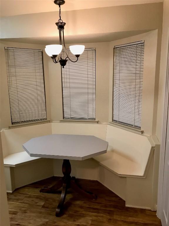 dining room featuring breakfast area, a chandelier, and wood finished floors