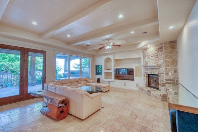 living area featuring recessed lighting, a fireplace, visible vents, beam ceiling, and stone tile flooring