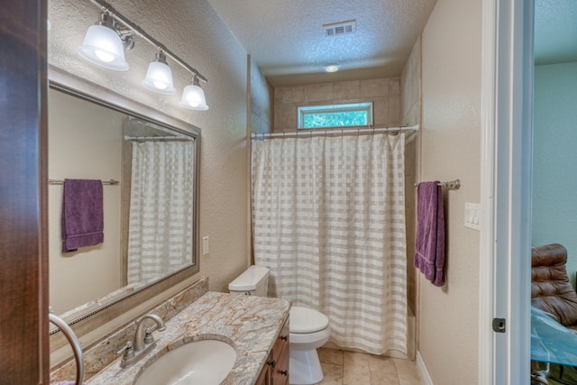 bathroom featuring a textured ceiling, a textured wall, toilet, vanity, and visible vents