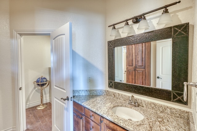 bathroom featuring a textured wall and vanity