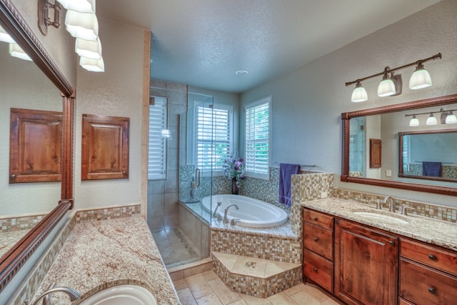 bathroom featuring a textured wall, a tile shower, vanity, a textured ceiling, and a bath