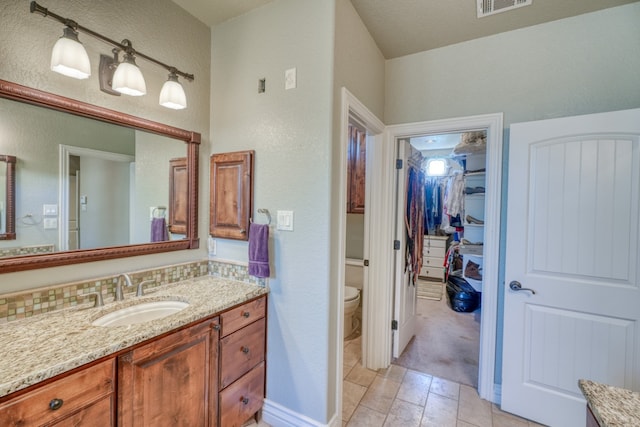 bathroom with toilet and vanity