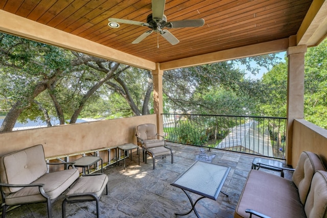 view of patio / terrace with a balcony and a ceiling fan