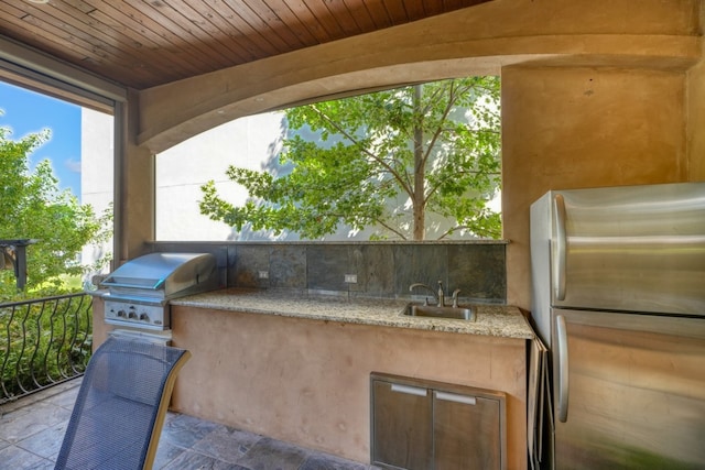 view of patio with area for grilling and a sink