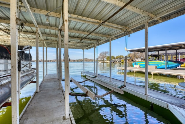 dock area with a water view and boat lift