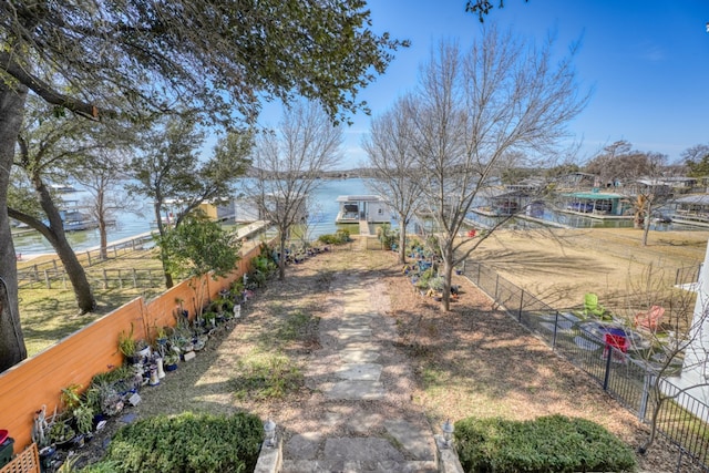 view of front of house featuring a water view and fence