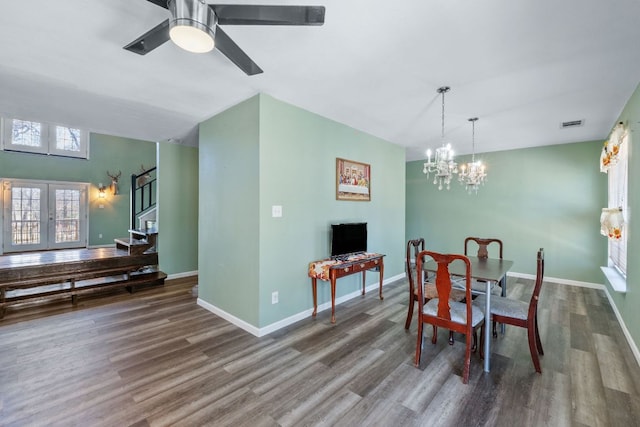 dining room with baseboards, wood finished floors, and french doors