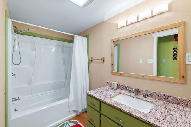 full bath featuring shower / bath combo with shower curtain, wood finished floors, and vanity