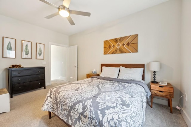 carpeted bedroom featuring a ceiling fan and baseboards