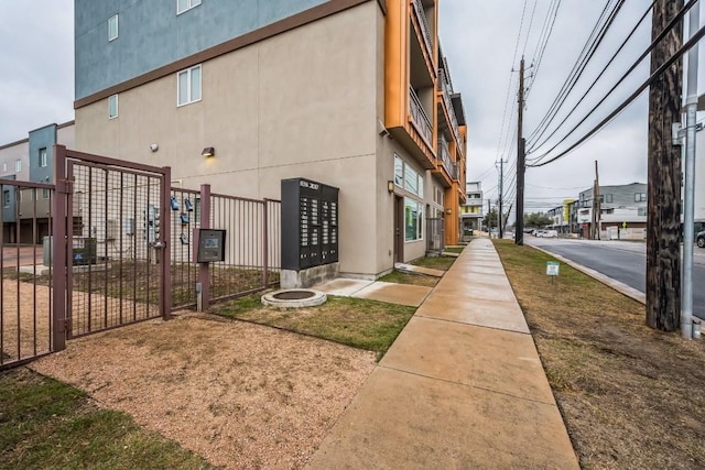 exterior space with mail area and fence