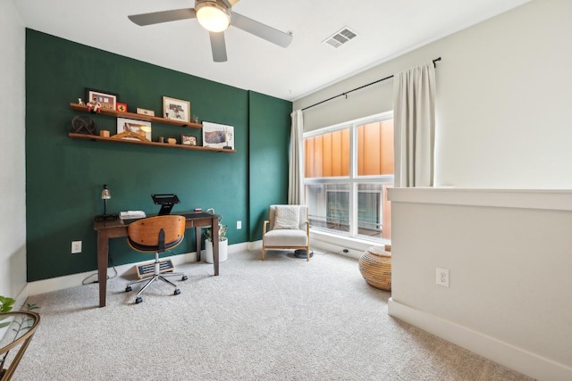 office with a ceiling fan, carpet, visible vents, and baseboards