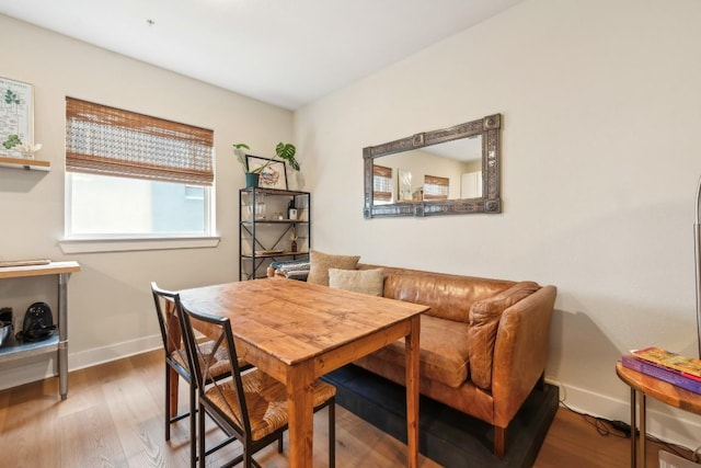 dining area featuring baseboards and wood finished floors