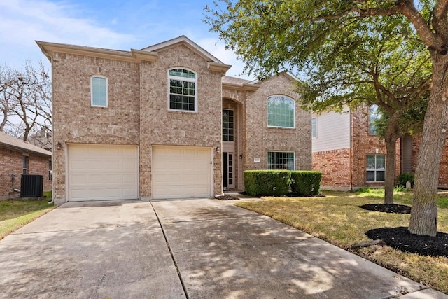 525 Golden Creek Dr, Round Rock, TX 78665 - traditional-style home with central AC unit, a garage, concrete driveway, a front lawn, and brick siding