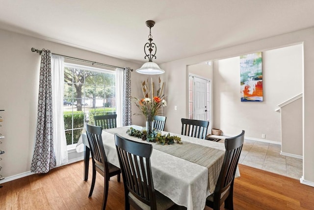 dining room with light wood finished floors and baseboards