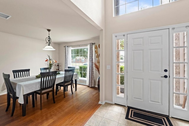 entryway with light tile patterned floors, visible vents, and baseboards