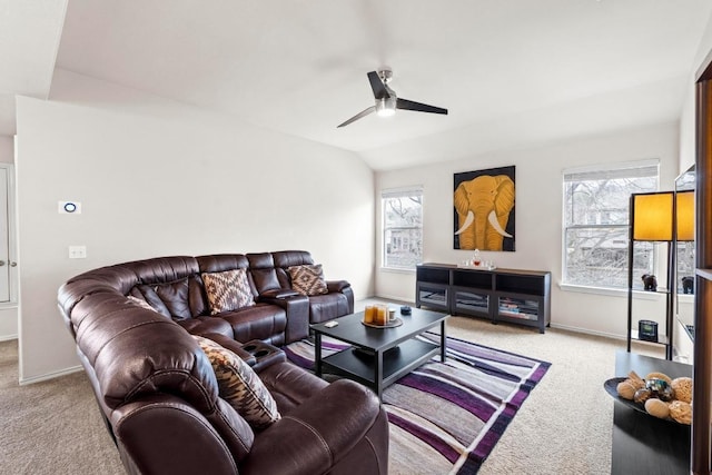 living room with vaulted ceiling, carpet flooring, a ceiling fan, and a healthy amount of sunlight