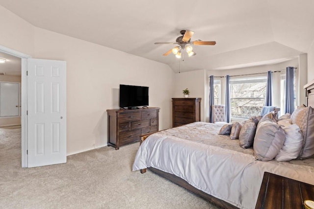 bedroom featuring lofted ceiling, a ceiling fan, and light colored carpet