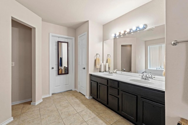 525 Golden Creek Dr, Round Rock, TX 78665 - bathroom featuring double vanity, tile patterned floors, and baseboards