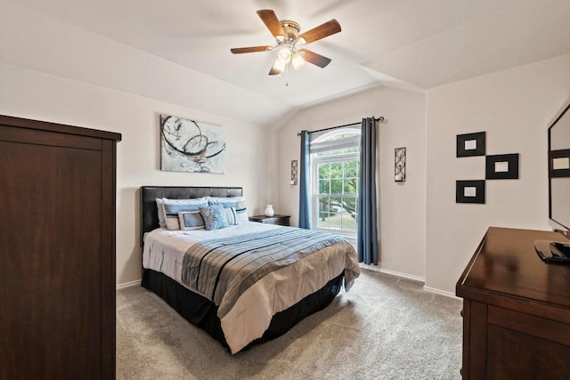 bedroom with baseboards, vaulted ceiling, a ceiling fan, and light colored carpet