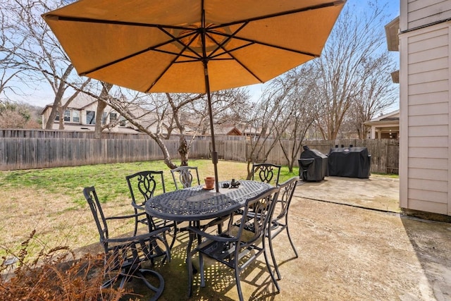 view of patio / terrace with outdoor dining space, area for grilling, and a fenced backyard