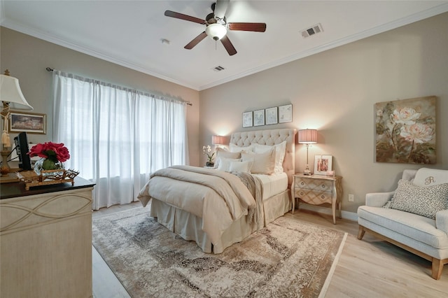 bedroom featuring visible vents, crown molding, and light wood-style flooring