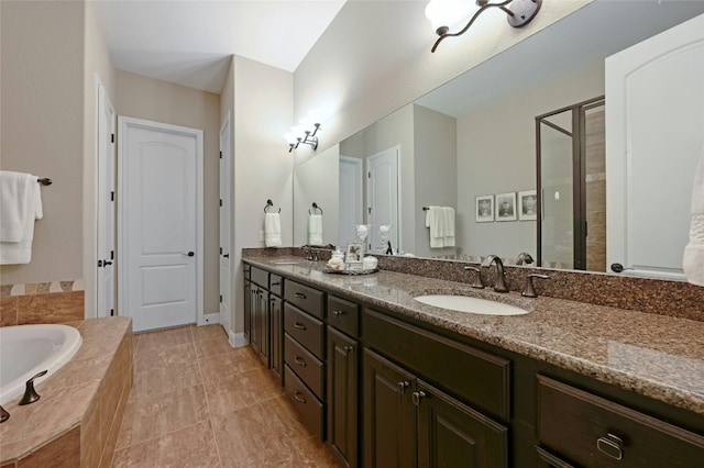 bathroom featuring a stall shower, a garden tub, a sink, and double vanity