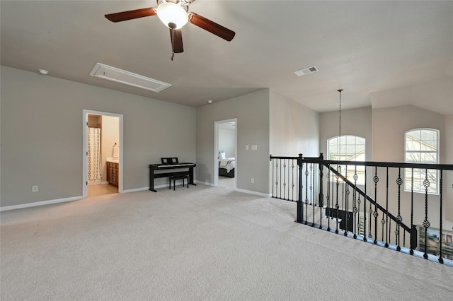 unfurnished room featuring attic access, visible vents, baseboards, and light colored carpet