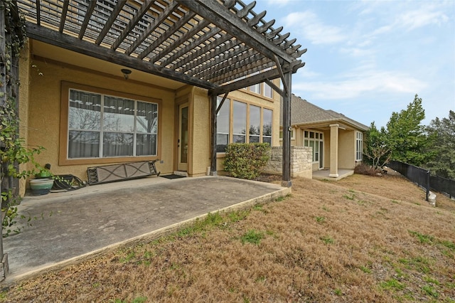 exterior space featuring a pergola, fence, a patio, and stucco siding