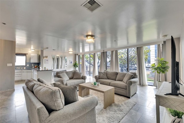 40 N Interstate 35 Hwy Unit 2D4, Austin, TX 78701 - living room featuring floor to ceiling windows and visible vents