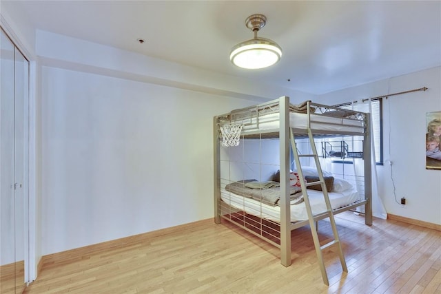 40 N Interstate 35 Hwy Unit 2D4, Austin, TX 78701 - bedroom with wood finished floors, baseboards, and a closet