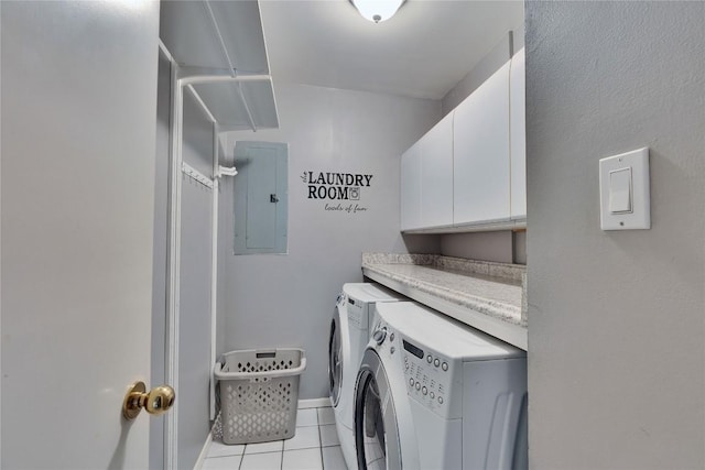 laundry room featuring light tile patterned floors, cabinet space, washer and dryer, electric panel, and baseboards