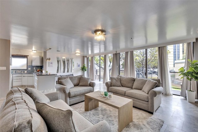 living room with light tile patterned flooring and floor to ceiling windows