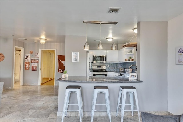 40 N Interstate 35 Hwy Unit 2D4, Austin, TX 78701 - kitchen with open shelves, visible vents, appliances with stainless steel finishes, a sink, and dark stone counters
