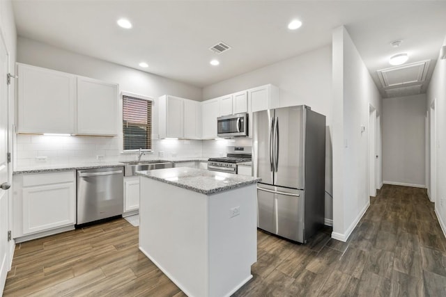 kitchen featuring visible vents, appliances with stainless steel finishes, white cabinetry, and a sink