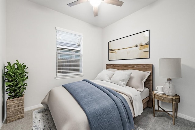 carpeted bedroom featuring baseboards and a ceiling fan