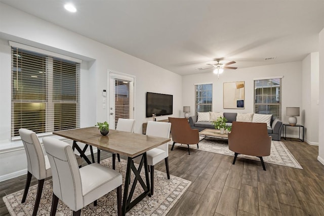 dining room with visible vents, a ceiling fan, dark wood-type flooring, and baseboards