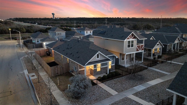 aerial view at dusk featuring a residential view