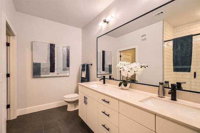 bathroom with toilet, baseboards, visible vents, and a sink